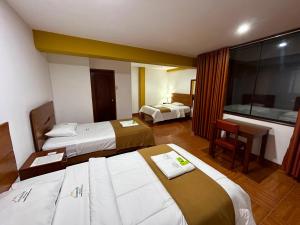 Postel nebo postele na pokoji v ubytování HOTEL LOS ANDES SUITE