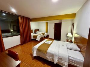 Postel nebo postele na pokoji v ubytování HOTEL LOS ANDES SUITE