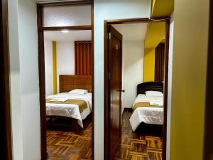 Postel nebo postele na pokoji v ubytování HOTEL LOS ANDES SUITE