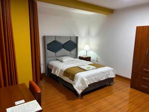 Postel nebo postele na pokoji v ubytování HOTEL LOS ANDES SUITE