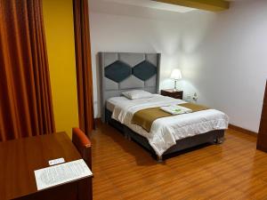 Postel nebo postele na pokoji v ubytování HOTEL LOS ANDES SUITE