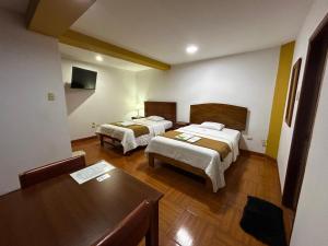 Postel nebo postele na pokoji v ubytování HOTEL LOS ANDES SUITE