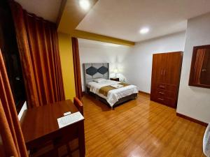 Postel nebo postele na pokoji v ubytování HOTEL LOS ANDES SUITE