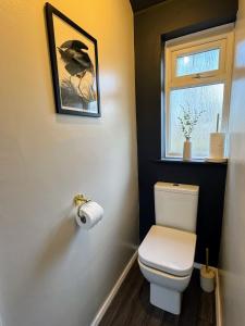 a bathroom with a toilet and a window at Luxury House sleeps 8 - Ideal for Solihull NEC - Work and Family Groups in Birmingham +24 photos