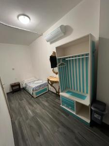 a small room with a bed and a dresser at Bike Hotel Oasi in Finale Ligure +21 photos