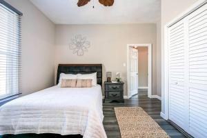a bedroom with a large bed and a window at Soak Stroll 2 State St Casino Firepit Dogs OK in Bristol