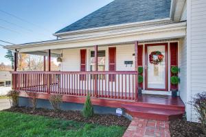 a house with a red porch with a wreath on it at Soak Stroll 2 State St Casino Firepit Dogs OK in Bristol