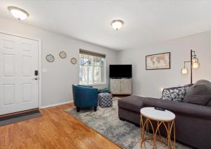 a living room with a couch and a table at Urban Escape Steps to Downtown in Boise