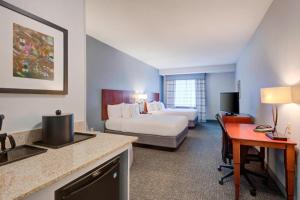 a hotel room with a bed and a desk at Courtyard Raleigh Crabtree Valley in Raleigh +24 photos