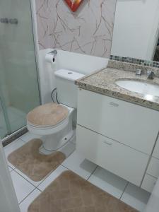 a bathroom with a toilet and a sink at Barra Rio Centro in Rio de Janeiro