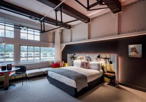 a hotel room with a large bed and a couch at Ovolo Woolloomooloo in Sydney
