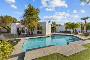 a swimming pool in the backyard of a home with a yard at Sumptuous 4br House W Private Heated Pool in Mesa