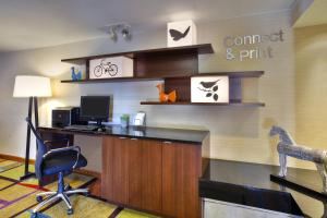 an office with a desk with a computer and a chair at Fairfield Inn Ann Arbor in Ann Arbor