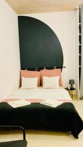 a bedroom with a large bed with a green headboard at AMOS HOMES accommodation in Bucharest