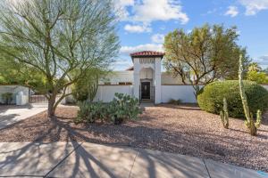 a white house with a tree and bushes at Sumptuous 4br House W Private Heated Pool in Mesa