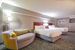 a hotel room with two beds and a couch at Courtyard Blacksburg in Blacksburg +10 photos