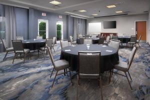 a conference room with tables and chairs and a screen at Fairfield Inn & Suites Chattanooga I-24/Lookout Mountain in Chattanooga +19 photos