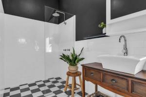 a bathroom with a sink and a glass shower at Settlers Cottage and Settle Inn in Broadwater +37 photos
