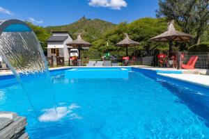 a pool with a fountain in the middle at Portal de la Virgen in Villa General Belgrano