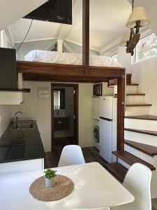 a small kitchen and dining room with a loft bed at Tiny House Mercedes in Mercedes