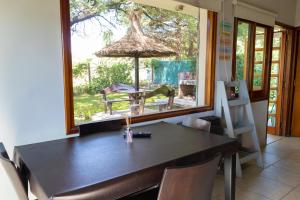 a dining room with a table and a large window at Portal de la Virgen in Villa General Belgrano