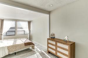 a bedroom with a bed and a dresser and a window at Waterfront Condo with Dock Access in Carlsbad! in Carlsbad +26 photos