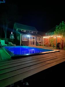 a swimming pool in front of a house at night at Los diablitos in Punta Del Diablo