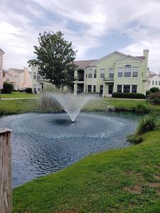 a fountain in a pond in front of a house at Legacy Villa 504 in Gulfport