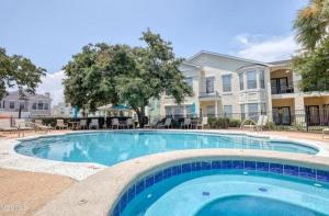 a large swimming pool in front of a building at Legacy Villa 504 in Gulfport
