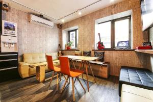 a living room with a table and chairs and a couch at Fully Mini Hotel in Seoul