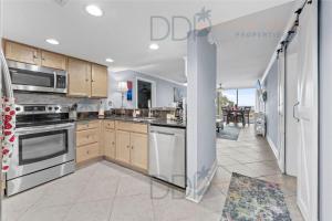 cocina con electrodomésticos de acero inoxidable y comedor en Ocean Club Villa B-220, en Biloxi