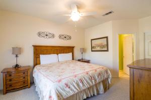 a bedroom with a bed and a ceiling fan at Legacy Villa 304 in Gulfport +39 photos