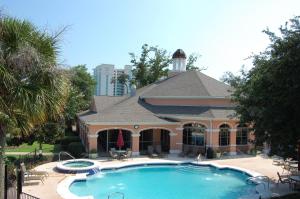 a house with a large swimming pool in front of it at Legacy Villa 304 in Gulfport