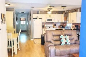 a living room with a couch and a kitchen at 24th Street House in Gulfport