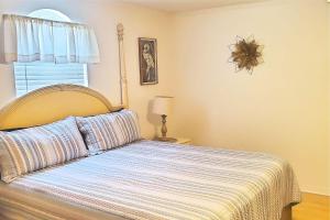 a bedroom with a bed with a striped blanket at 24th Street House in Gulfport