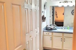 a bathroom with a sink and a mirror at 24th Street House in Gulfport +10 photos