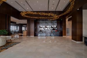a lobby of a hotel with a chandelier at Courtyard by Marriott Surat in Surat