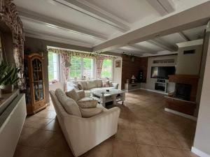 a living room with a couch and a table at Lawendowy Dom in Spychowo