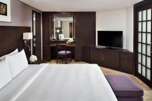 a hotel room with a bed and a television at Courtyard by Marriott Riyadh Diplomatic Quarter in Riyadh +25 photos