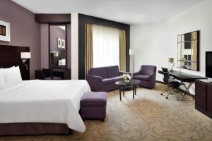 a hotel room with a bed and a desk at Courtyard by Marriott Riyadh Diplomatic Quarter in Riyadh