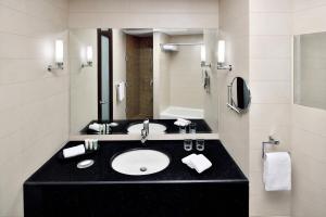 a bathroom with a sink and a mirror at Courtyard by Marriott Riyadh Diplomatic Quarter in Riyadh