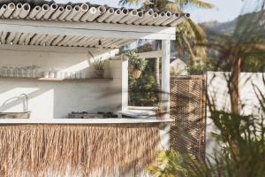an outdoor kitchen with a sink and a window at Nalua Boutique Hotel in Kuta Lombok
