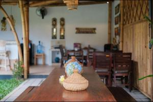 a vase sitting on top of a wooden table at Villa Felise Sanur in Sanur