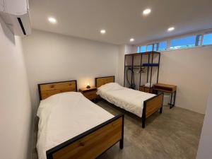a bedroom with two beds and a window at 2 Bedder Beach Front Condo in Prime Location in Hua Hin +24 photos