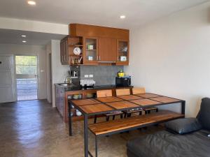 a living room with a table and a kitchen at 2 Bedder Beach Front Condo in Prime Location in Hua Hin