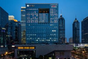 a tall building in a large city at night at Courtyard by Marriott Suzhou in Suzhou