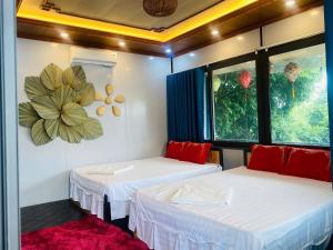 a room with two beds and a flower on the wall at Hang Mua Bungalow in Ninh Binh +81 photos