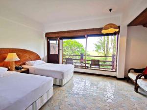 Postel nebo postele na pokoji v ubytování Rayong Resort Hotel โรงแรมระยองรีสอร์ท