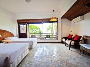 Postel nebo postele na pokoji v ubytování Rayong Resort Hotel โรงแรมระยองรีสอร์ท
