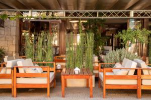 a group of chairs and tables in front of a building at Coronado Hotel in Mina Clavero